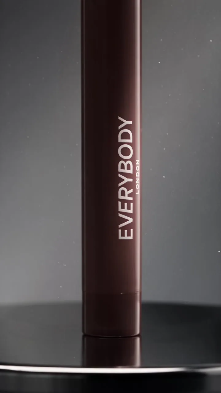 Dark lipstick tube with the word Everybody on a black set